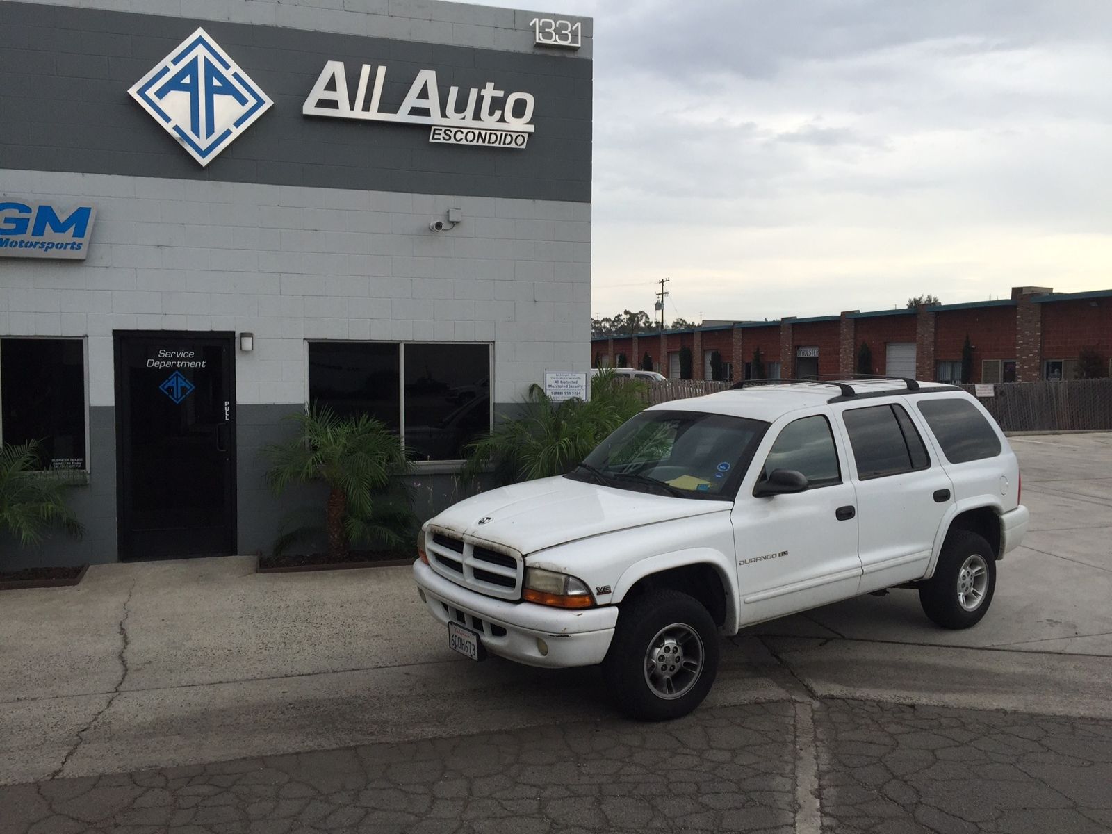 White Dodge Durango parked in front of the All Auto Escondido shop